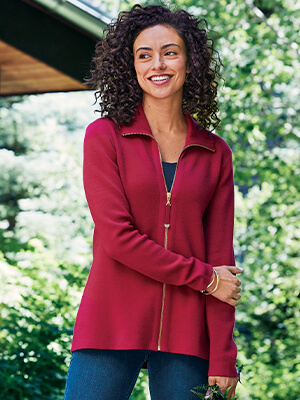 Image of a woman outside wearing the red Meria Zip Cardi